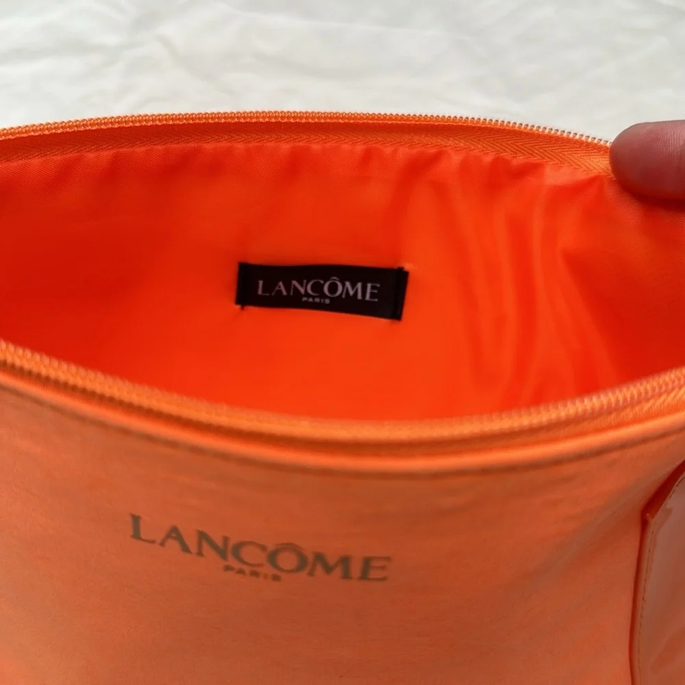 BEAND NEW! Vibrant Orange Cosmetic Bag with Glossy Finish and Zipper Closure.